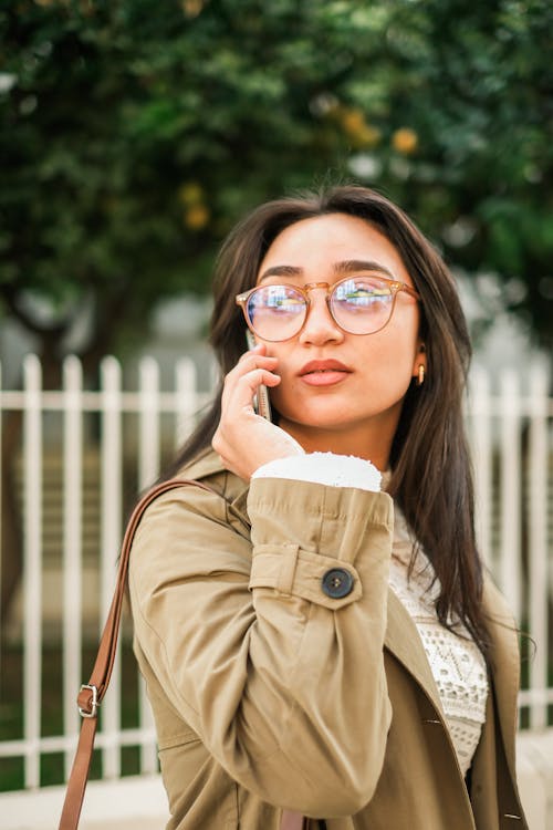 Free Portrait of Woman in Eyeglasses Talking on Phone Stock Photo