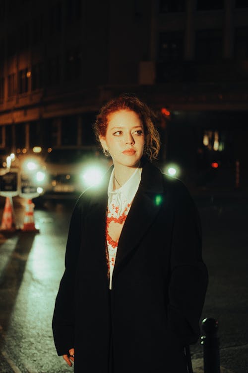 Woman in Coat in City at Night