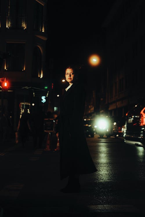 Woman Wearing Black Coat on a Street at Night 