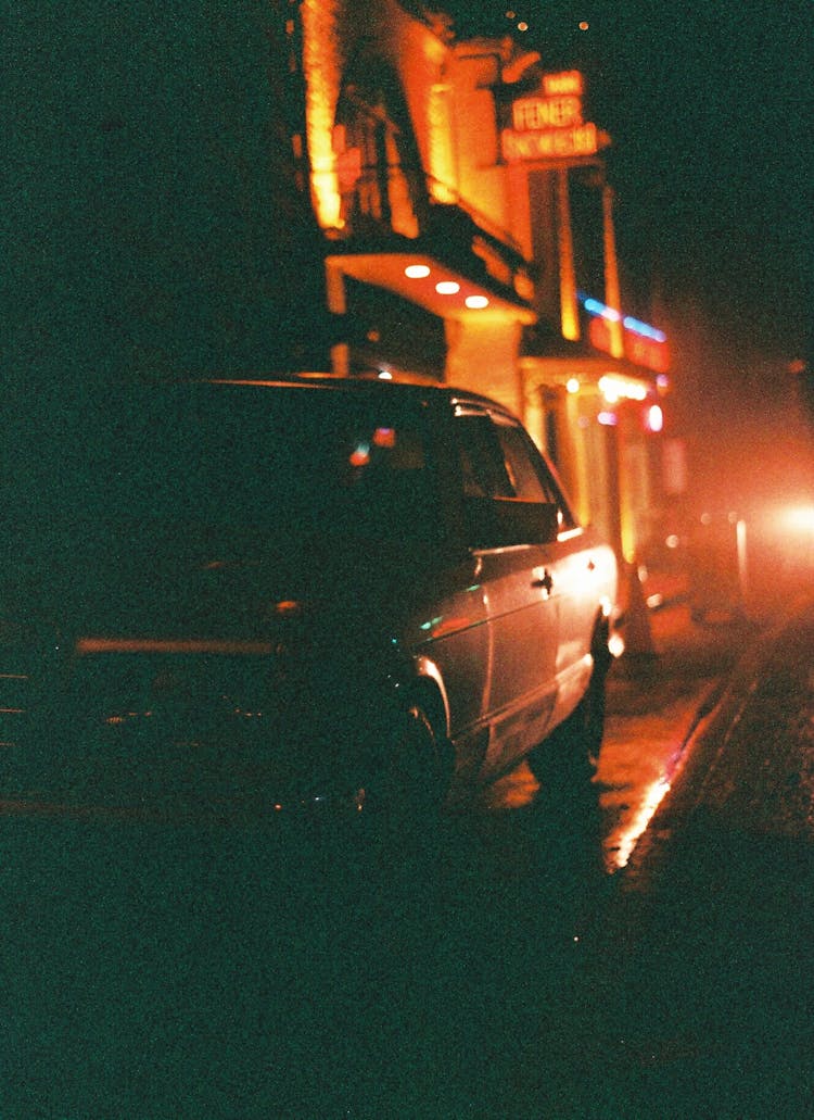 Film Photograph Of A Dark Street In City At Night 