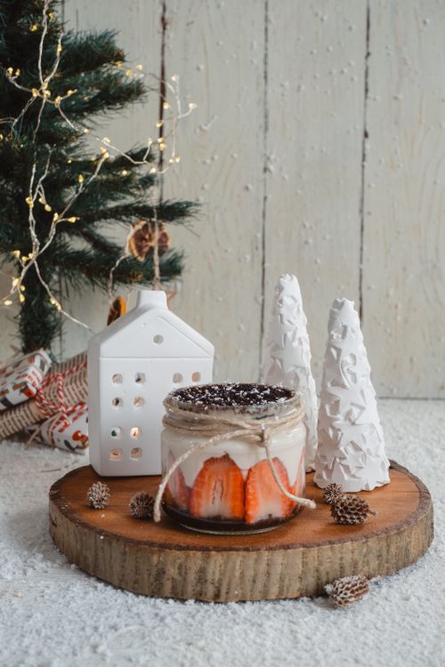 Free Festive dessert jar with holiday decorations and Christmas tree in background. Stock Photo