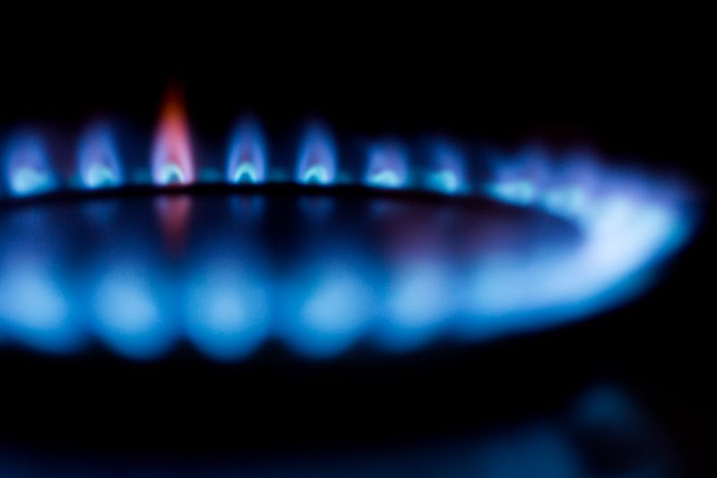 Blue flame burning on a gas stove burner