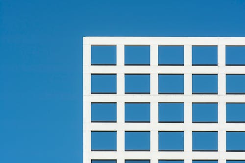 A Modern Construction with Windows against Clear Blue Sky 