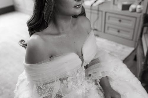 Black and White Photo of a Bride Sitting in a Room before the Wedding 