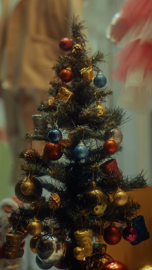 Close-up of a Small Christmas Tree with Colorful Baubles