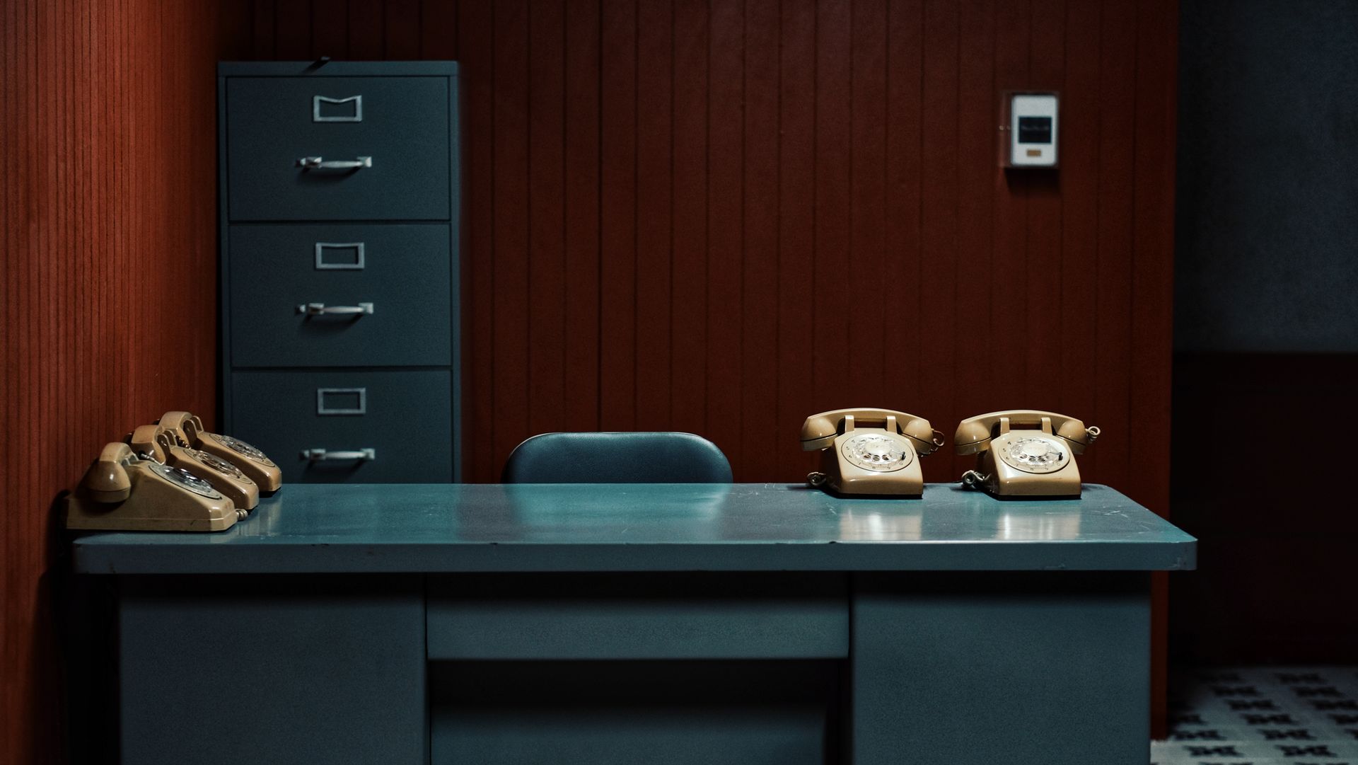 Retro-themed office interior featuring vintage telephones and a filing cabinet.
