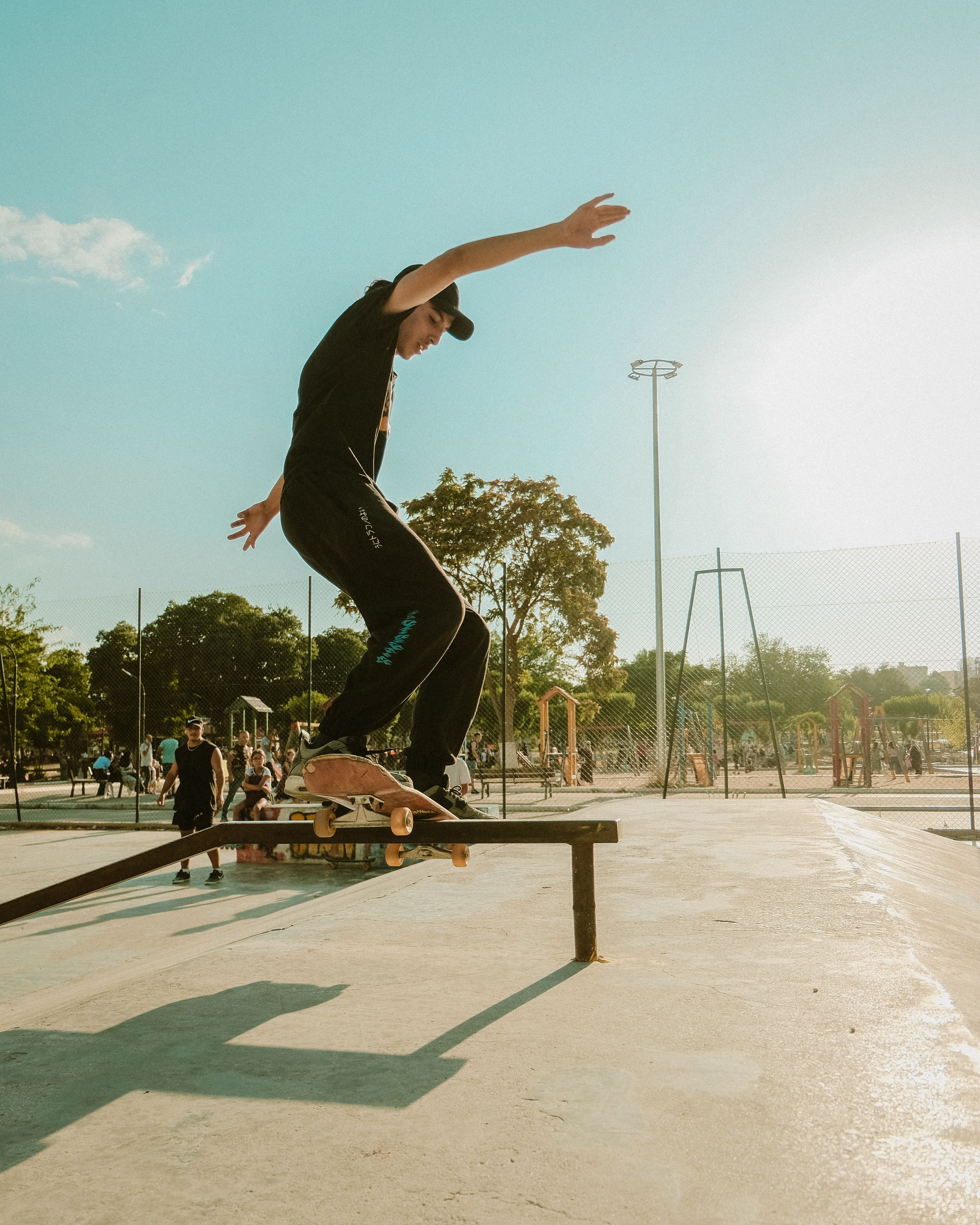 Teenager Skating on a Railing in a Park · Free Stock Photo