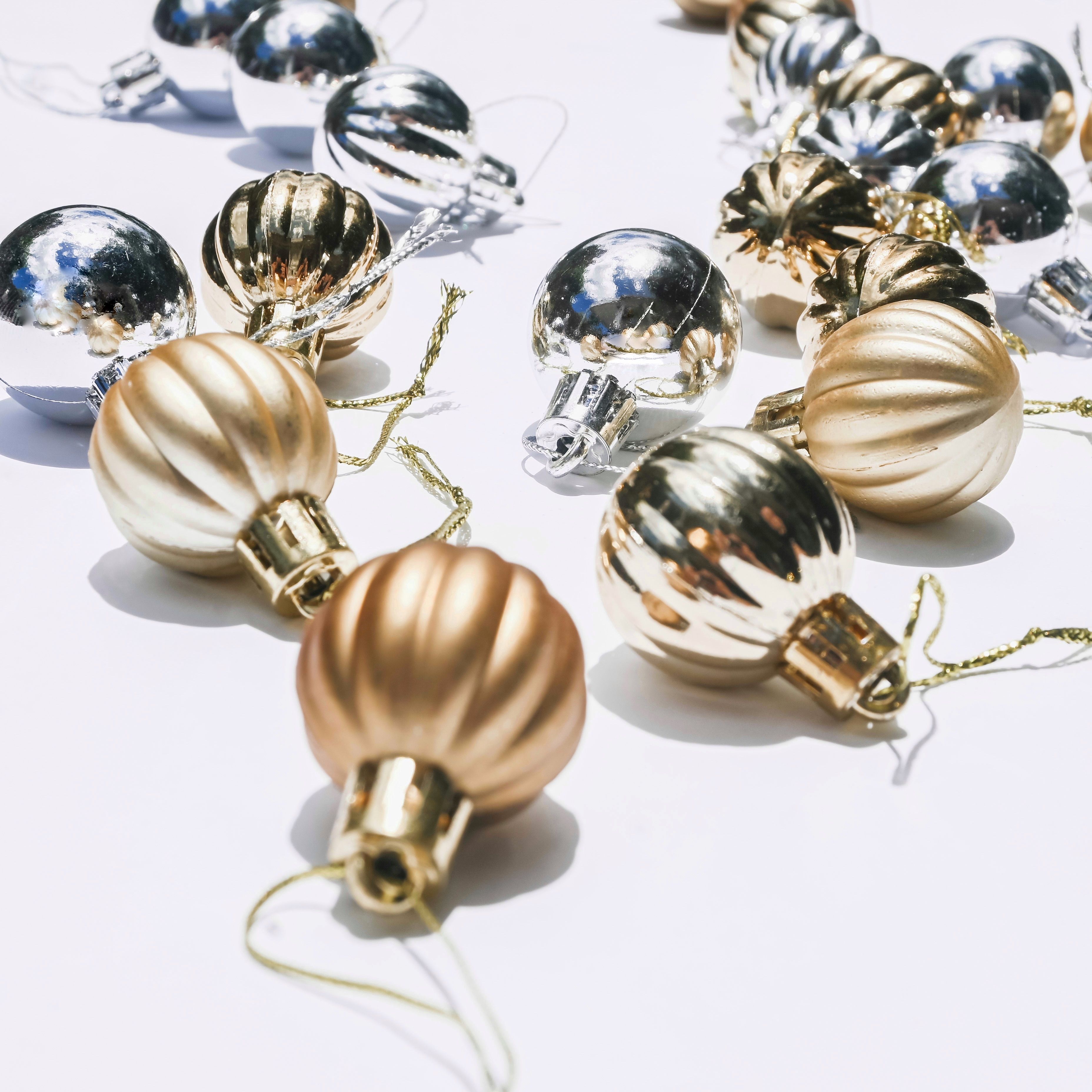 Stylish arrangement of gold and silver Christmas ornaments capturing festive elegance with a minimalist touch.