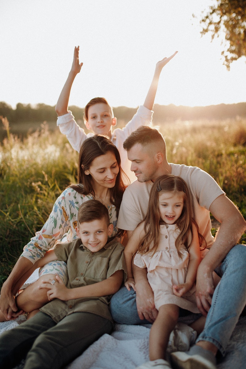 Family sitting together on a meadow