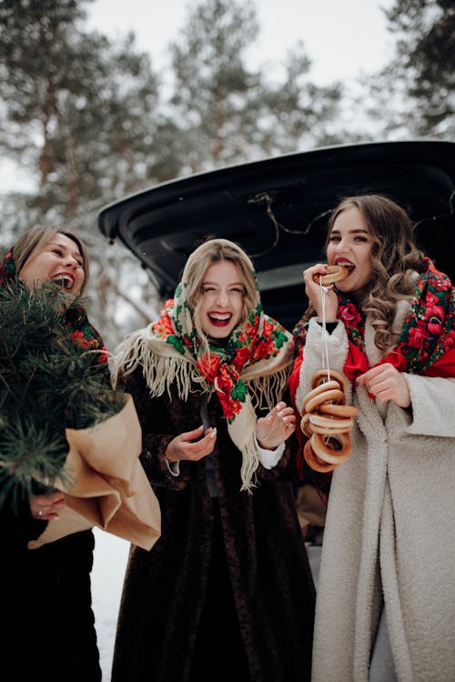 Pretty Women in Coats with Christmas Tree