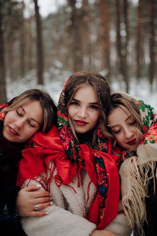 Young Women with Scarfs Posing Together in Winter