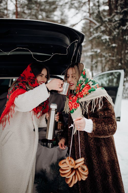 Woman Treat Friend to Hot Drink in Winter Forest by Car