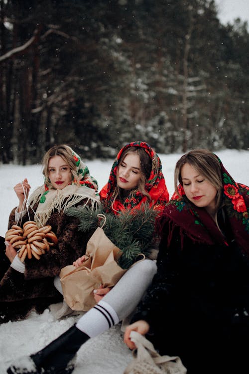 Women in Floral Headscarf Sitting on Snow
