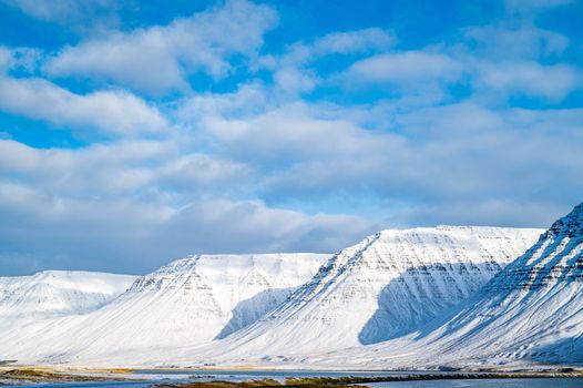Snow on Hills on Sea Shore