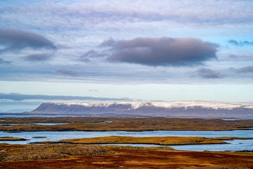 View of Shore and Snowcapped Mountains 