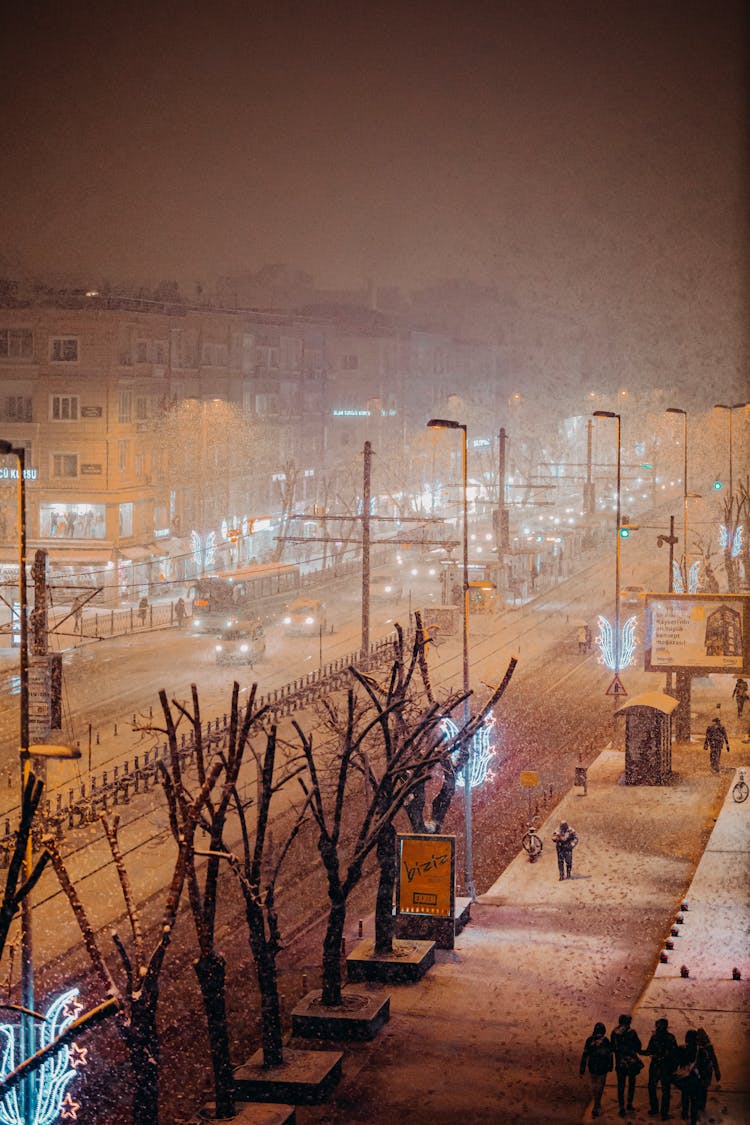 People Walking On City Street In Snow Storm