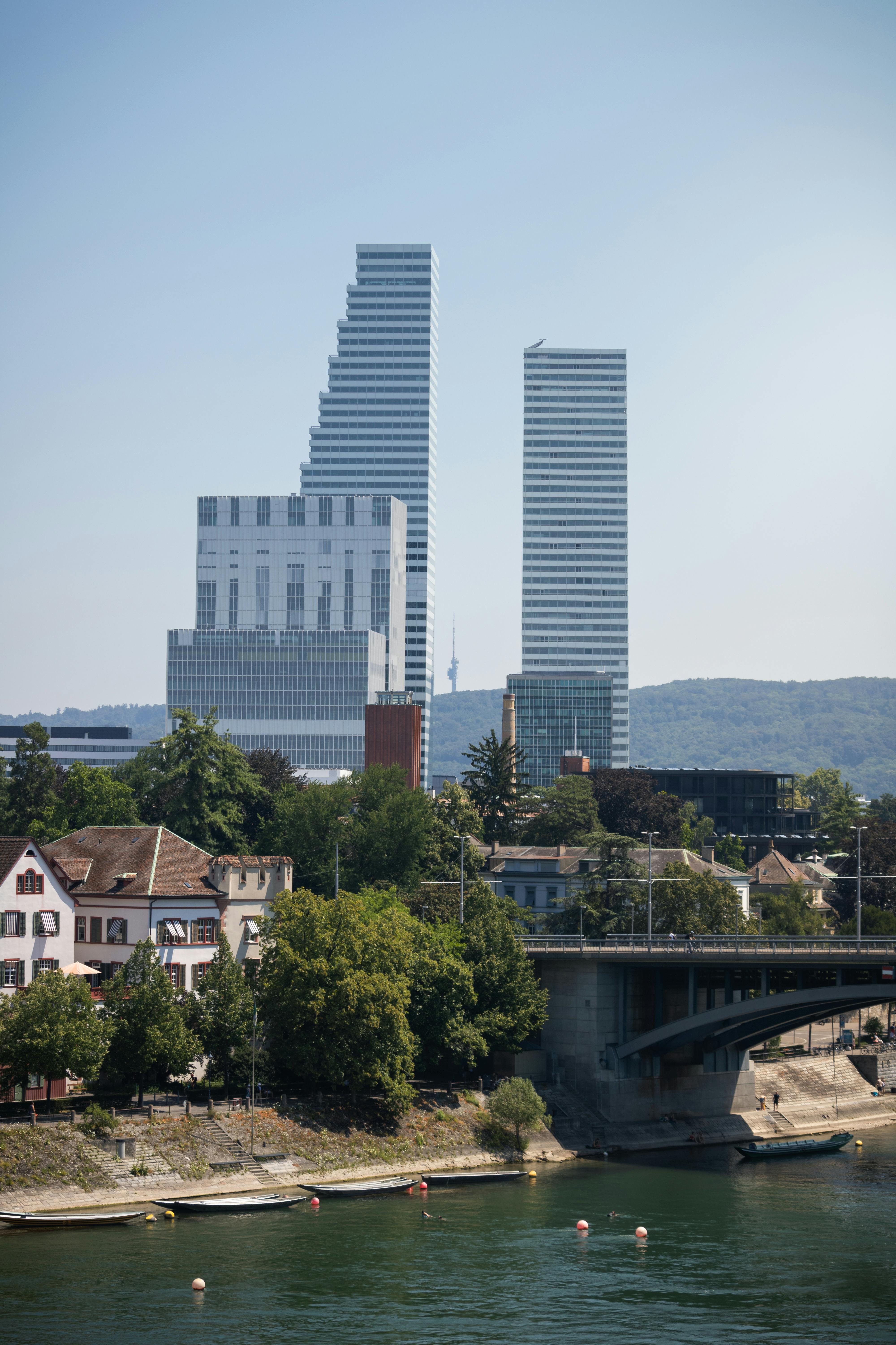 a river with a bridge and buildings in the background