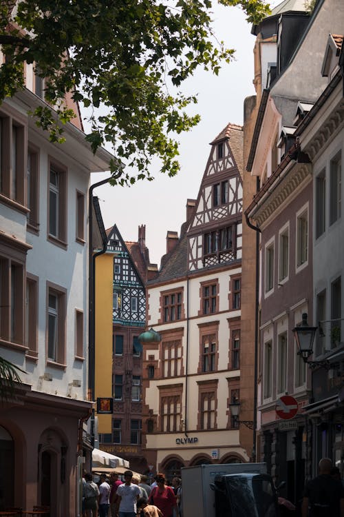 A street with many buildings and people walking