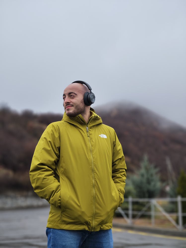 Smiling Man In Wireless Headphones And Jacket 