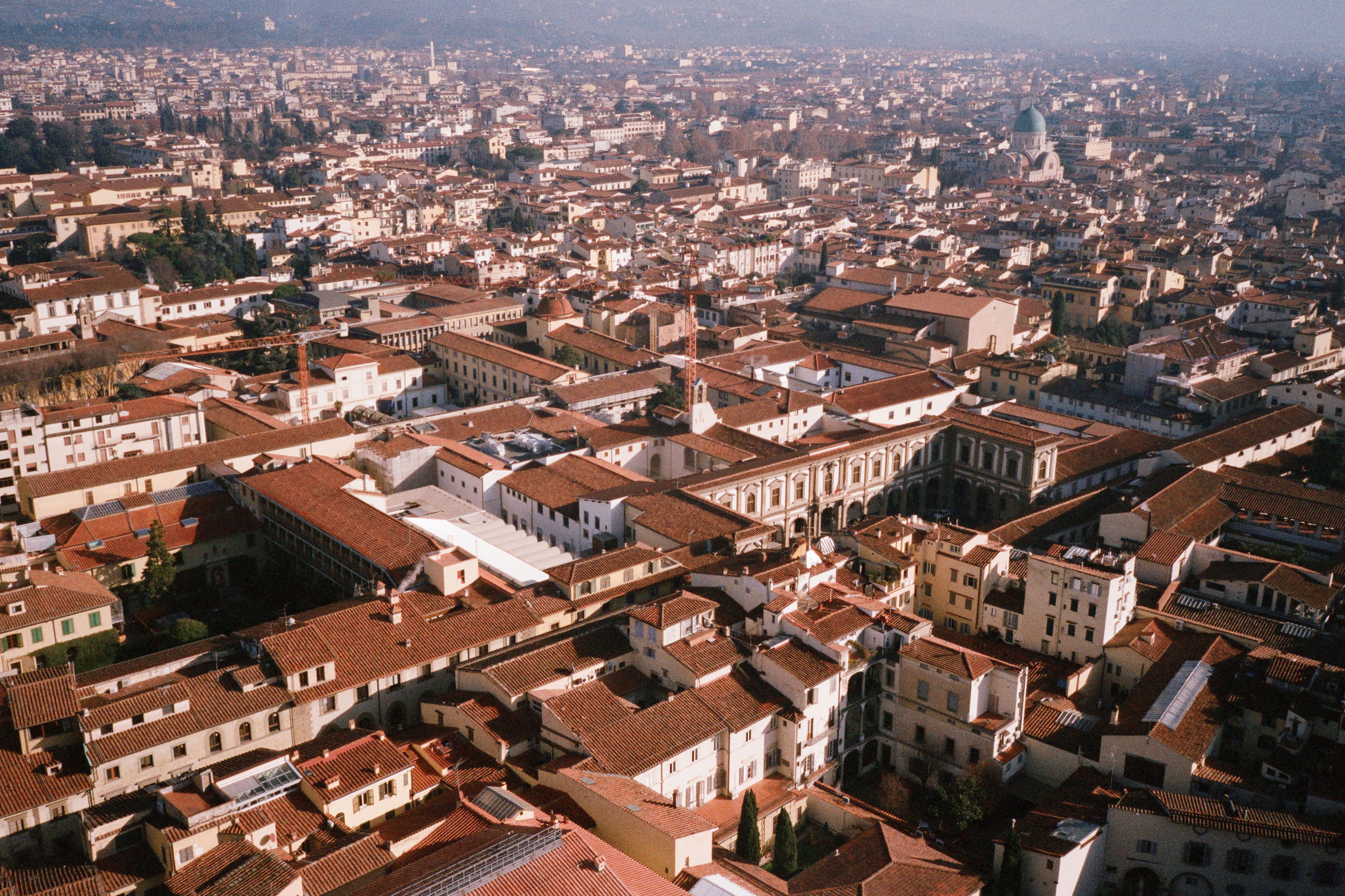 Aerial view of an Italian city showing urban and surrounding landscape