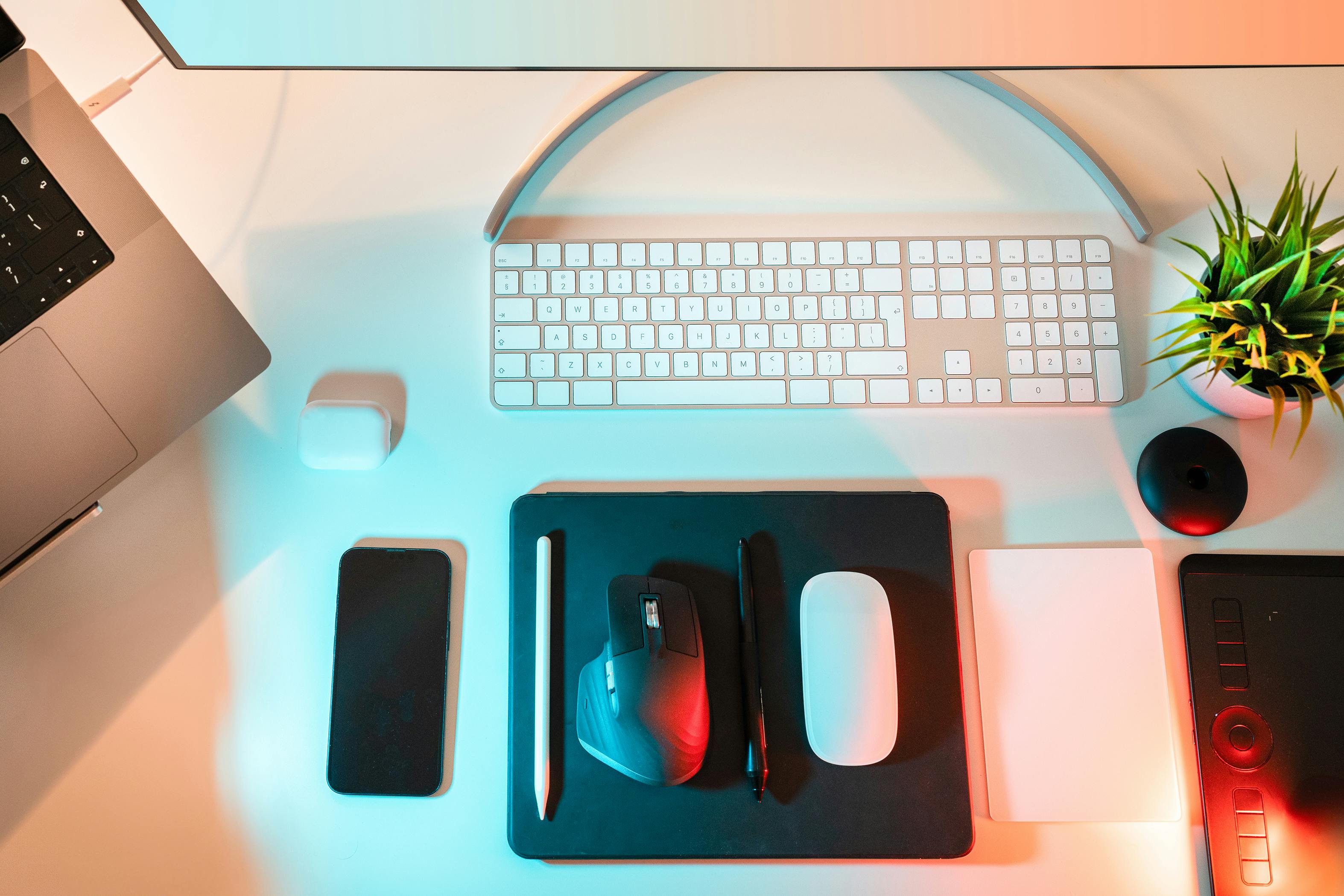 Overhead view of a modern workspace featuring wireless devices and stylish tech accessories.