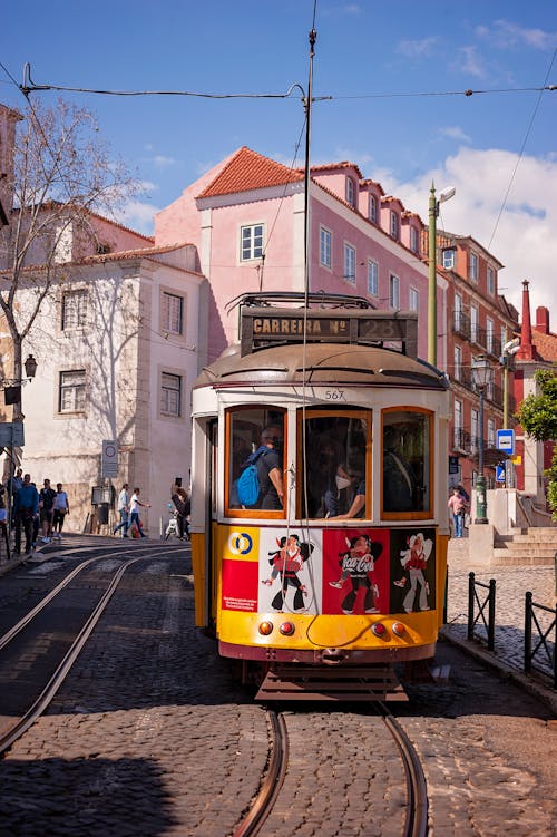 Vintage Tram on Cobblestone Street in Lisbon