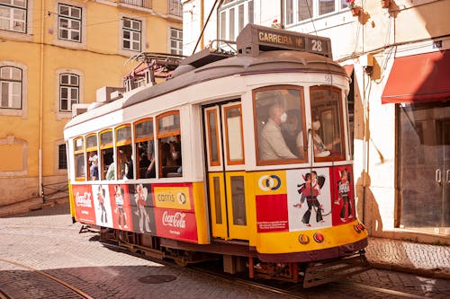Historic Tram Line 28 in Lisbon with a Coca-Cola Advertisement