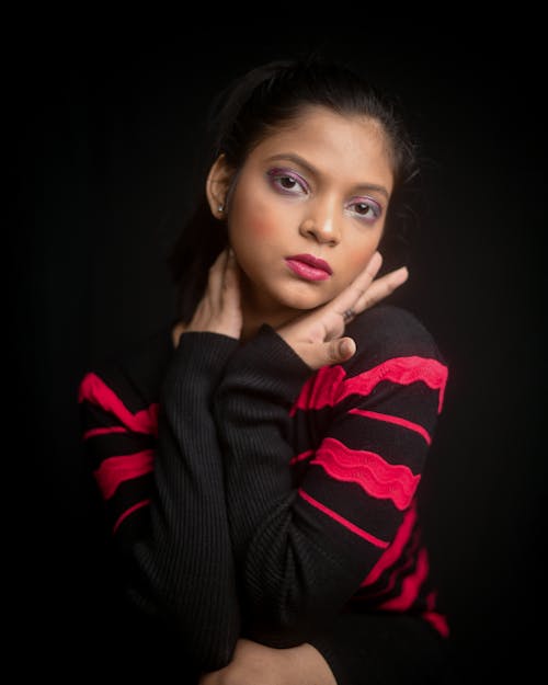 Studio Shot of a Young Girl Wearing Makeup with Purple Eyeshadow 