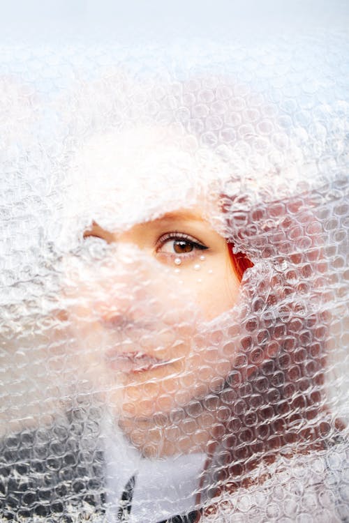 Portrait of Woman with Bubble Wrap on Face