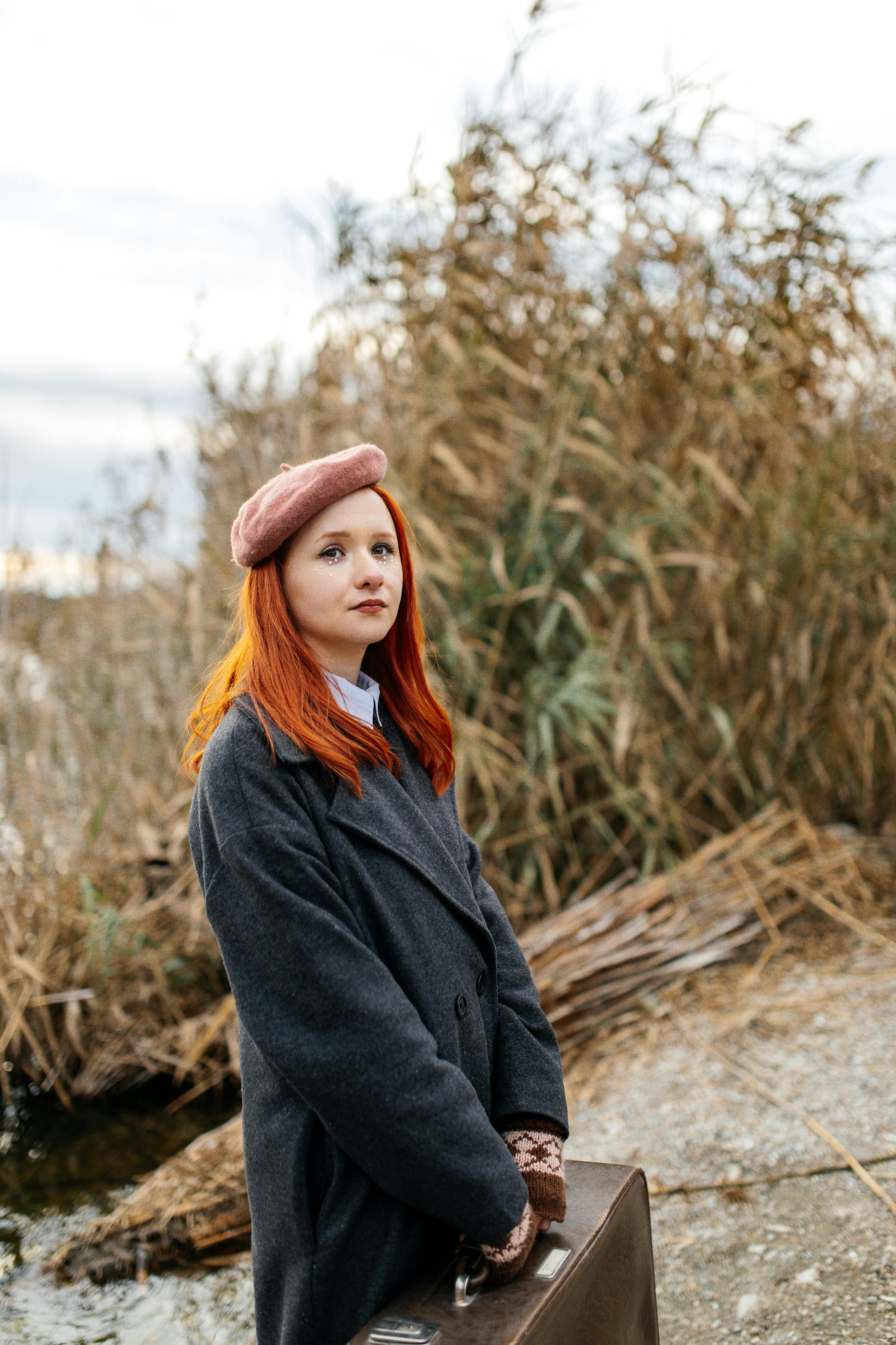 redhead woman in coat and beret