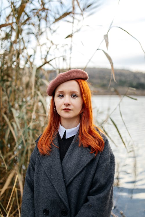 Portrait of Redhead Woman in Beret on Riverbank