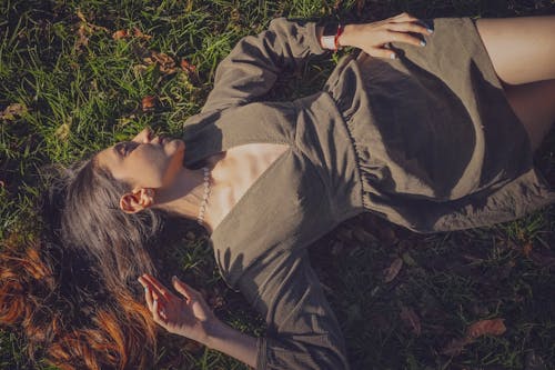 Woman in Dress Lying Down on Ground