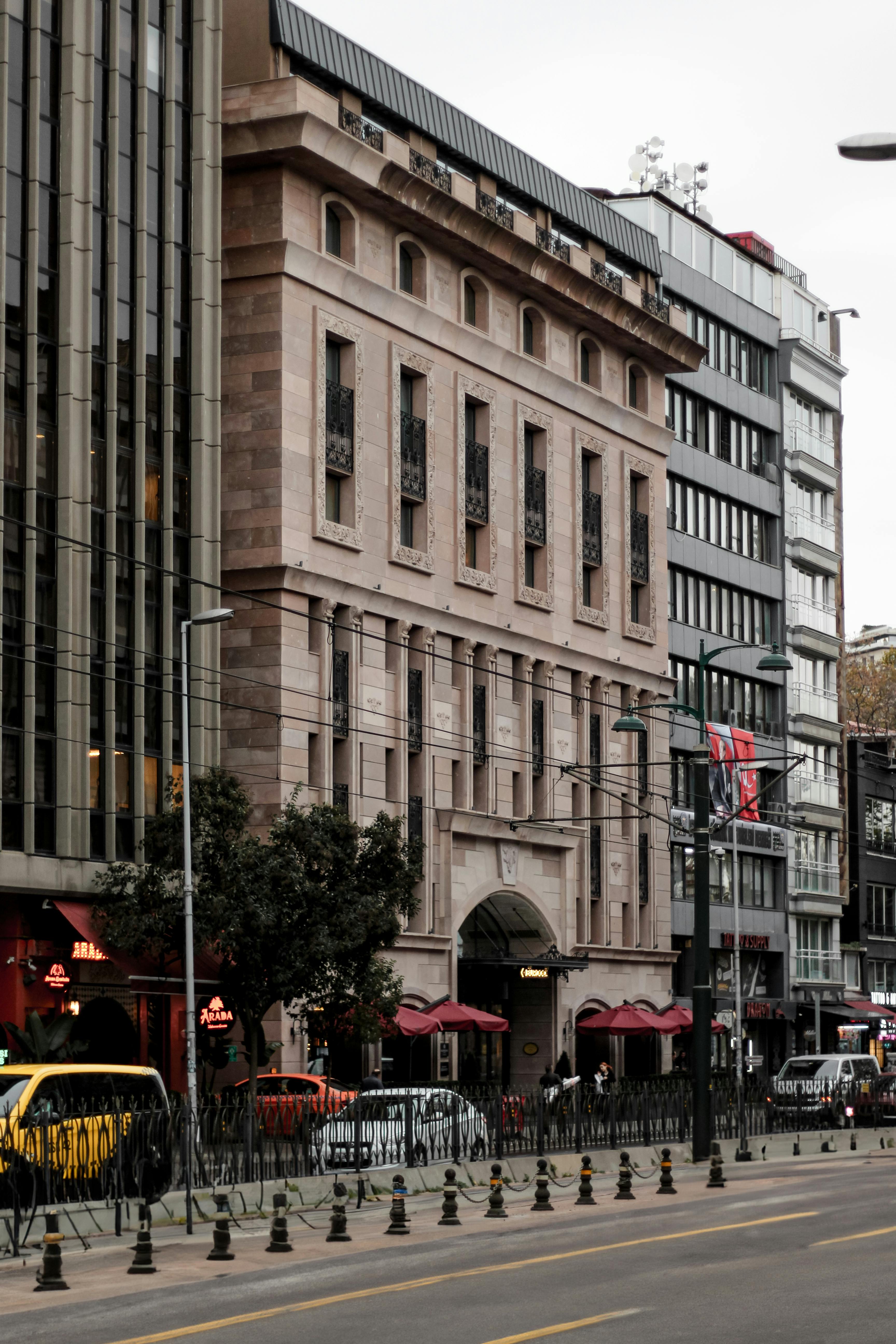An elegant historic building in a bustling Istanbul street, showcasing urban architecture.