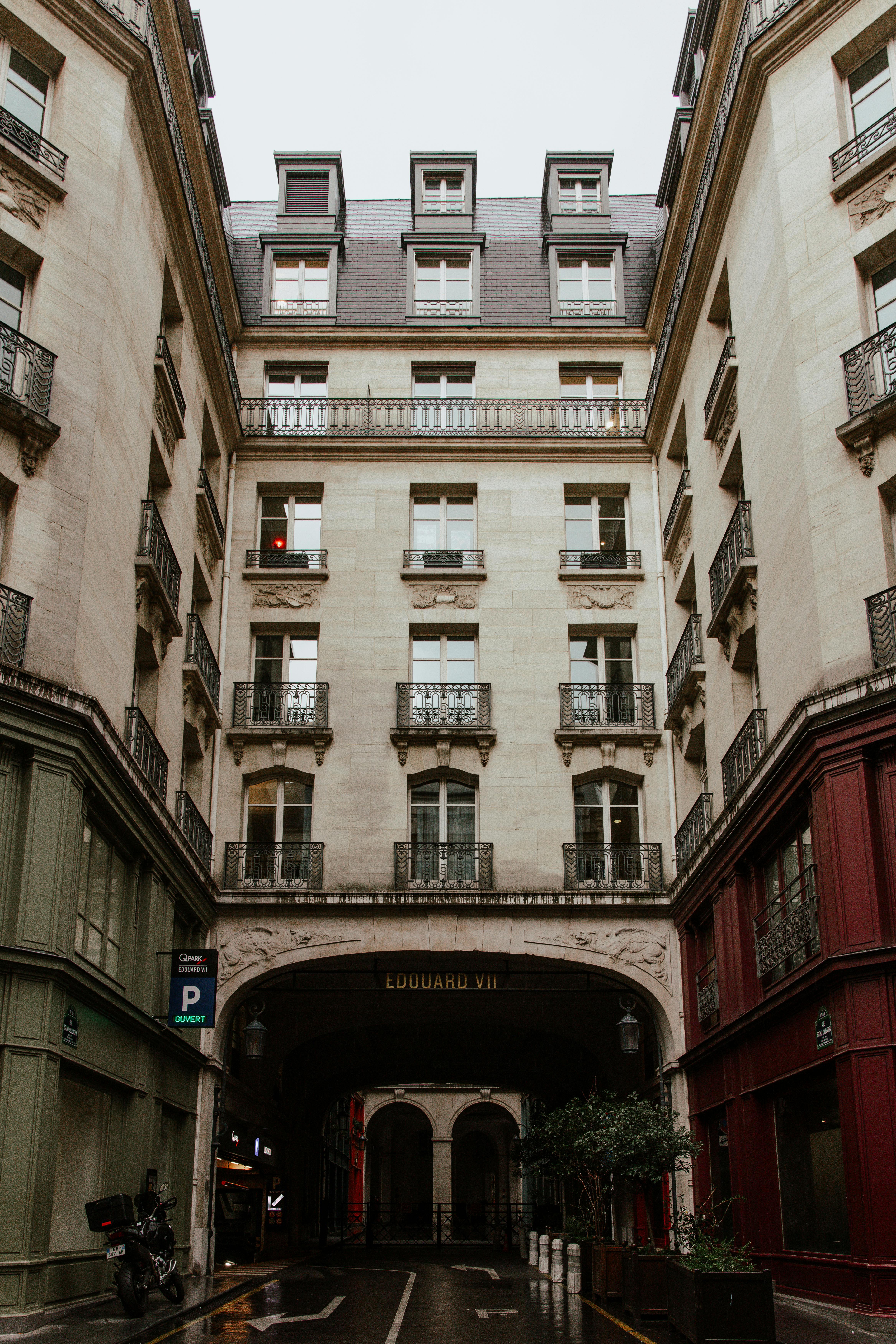 Elegant view of a traditional Parisian building facade on a city street.