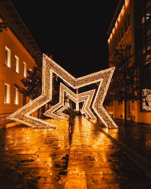 Large Illuminated Christmas Stars on Street in Town