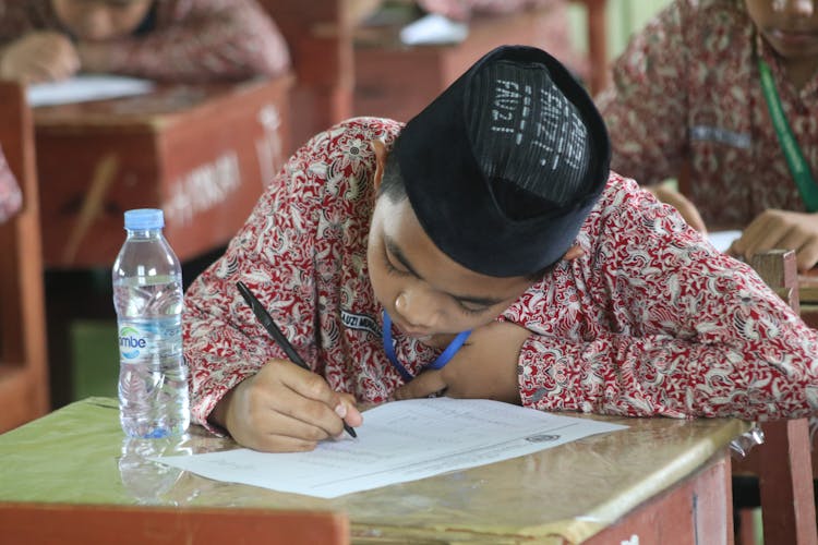 A Boy Taking A Test At School