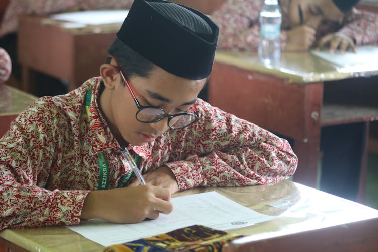 A Boy Taking A Test At School