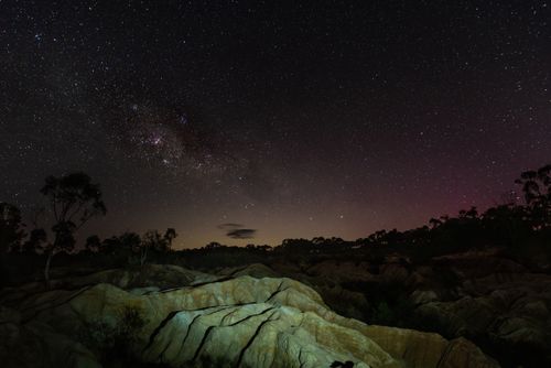 Free Stunning night sky over rocky landscape in Heathcote, Australia, with vibrant star field. Stock Photo