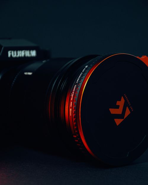 Free Dramatic close-up of a camera lens lit with red, emphasizing the technology theme. Stock Photo