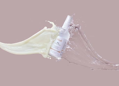 High-speed capture of milk and water splashing around a facial toner bottle, highlighting skincare product.
