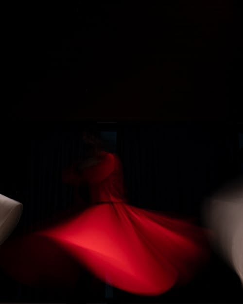 Blurred Motion of Dancing Woman in Red Dress