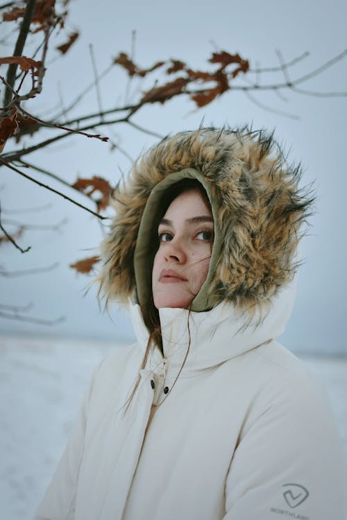 Young Woman in a Winter Jacket with a Fur-Trimmed Hood