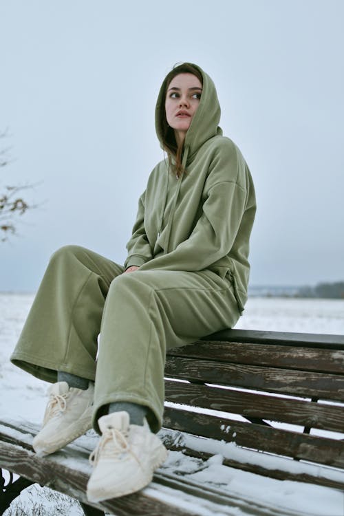 Woman in Tracksuit on Bench in Winter