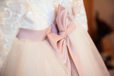 Lace fabric with a pink satin bow detail.