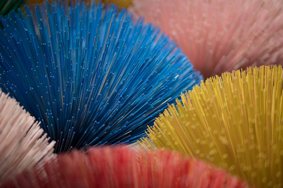 Colorful close-up of fiber optic bundles forming an abstract pattern with vivid hues.