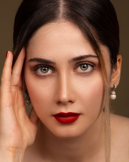 Studio Portrait of a Young Woman in Glamour Makeup with Red Lips 