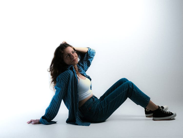 Woman Sitting On Floor In Studio