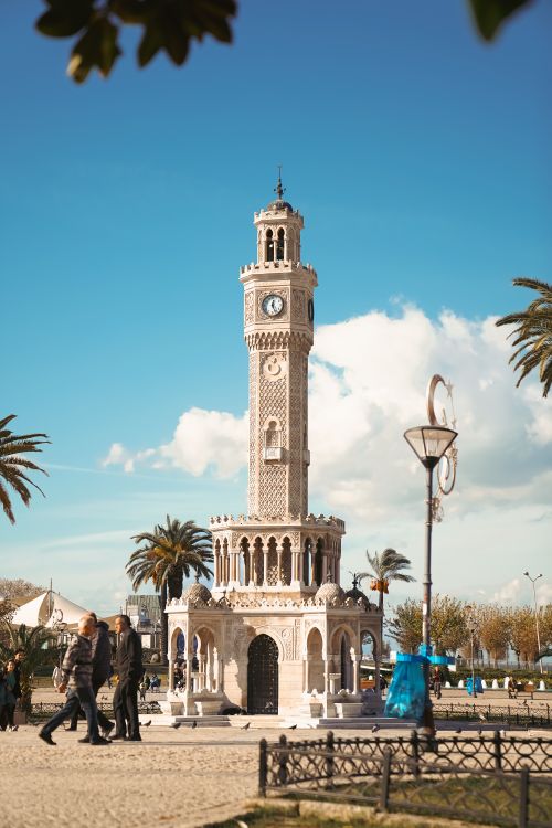 Free Iconic Izmir clock tower at Konak Square surrounded by palm trees and visitors. Stock Photo
