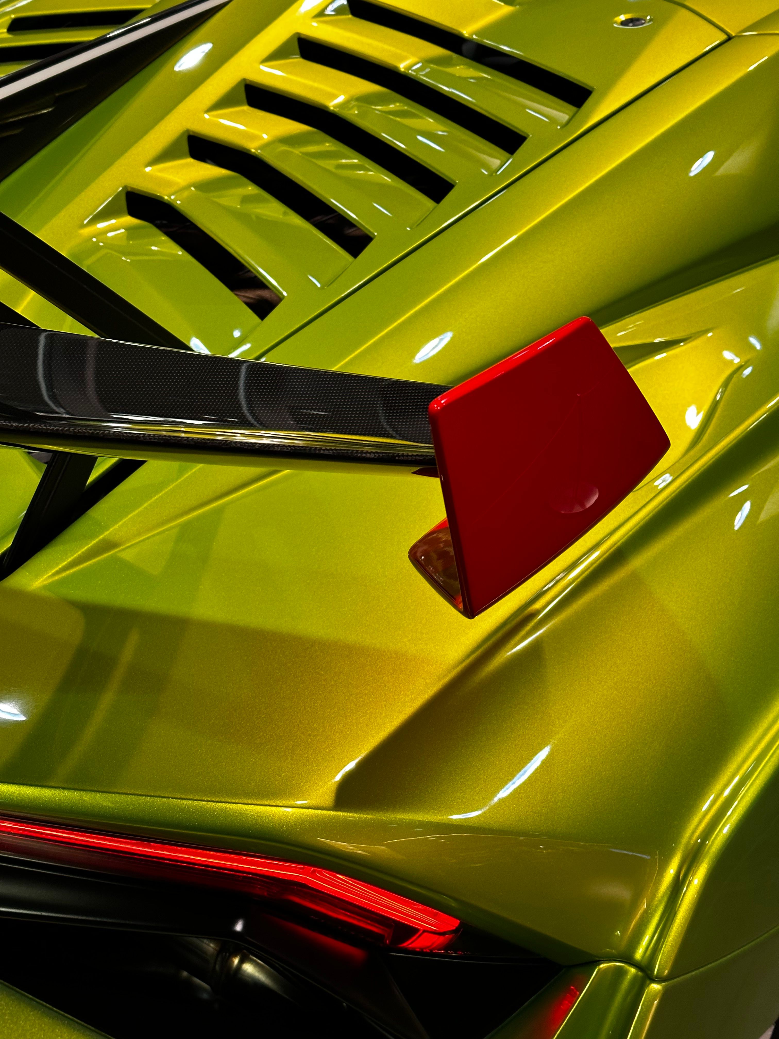 The rear end of a sports car with a red tail · Free Stock Photo