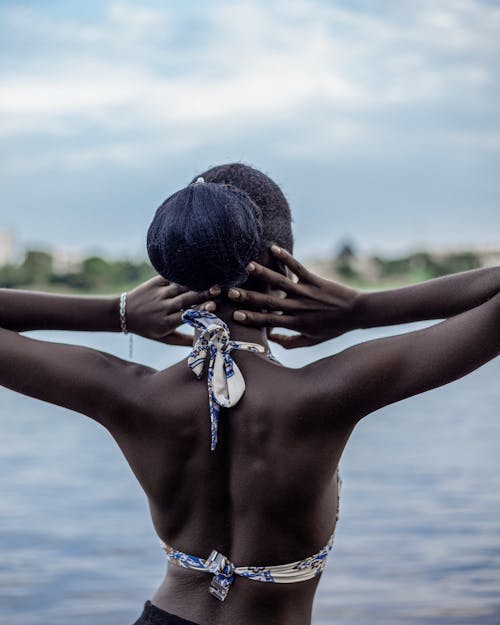 Back View of a Woman in Bikini Standing by the Water 